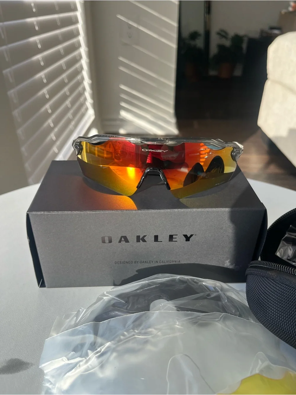 Oakley Clear Frame Sport Sunglasses with Red-Orange Mirror Lenses